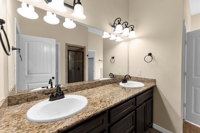 bathroom featuring tile patterned flooring, an enclosed shower, and vanity