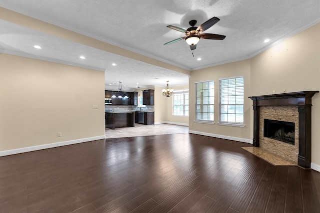 unfurnished living room with hardwood / wood-style floors, a textured ceiling, and crown molding