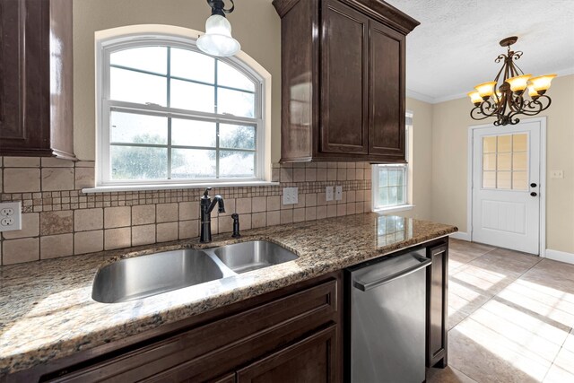 kitchen with dark brown cabinetry, sink, light stone counters, tasteful backsplash, and stainless steel dishwasher