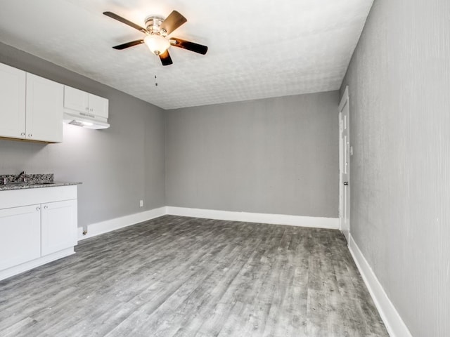 interior space featuring light wood-type flooring, sink, and ceiling fan