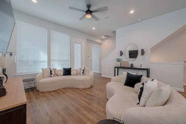 living room featuring light hardwood / wood-style floors and ceiling fan