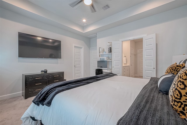 carpeted bedroom featuring ceiling fan and ensuite bathroom