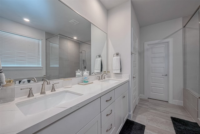 bathroom with vanity, wood-type flooring, and a shower with shower door