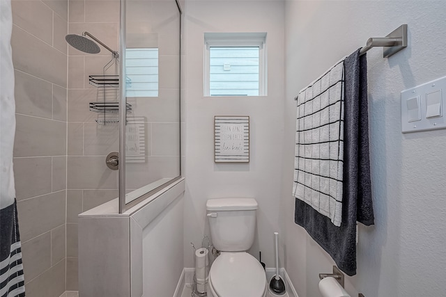 bathroom featuring toilet and a shower with shower curtain