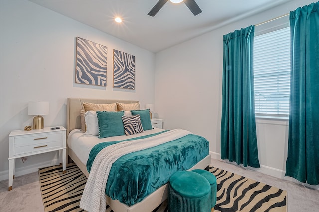 bedroom featuring light colored carpet and ceiling fan