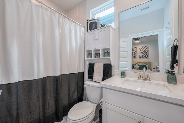 bathroom with ceiling fan, vanity, and toilet