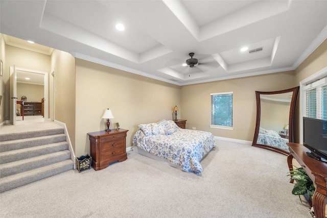 bedroom with carpet flooring, ceiling fan, crown molding, and a tray ceiling