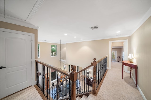 corridor with light colored carpet and ornamental molding