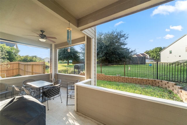 sunroom / solarium featuring ceiling fan