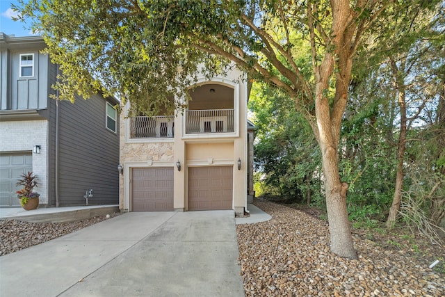 view of front of home featuring a balcony and a garage