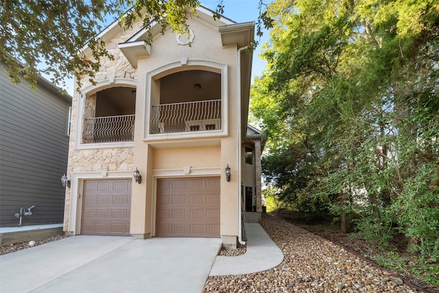 view of front of property featuring a balcony and a garage