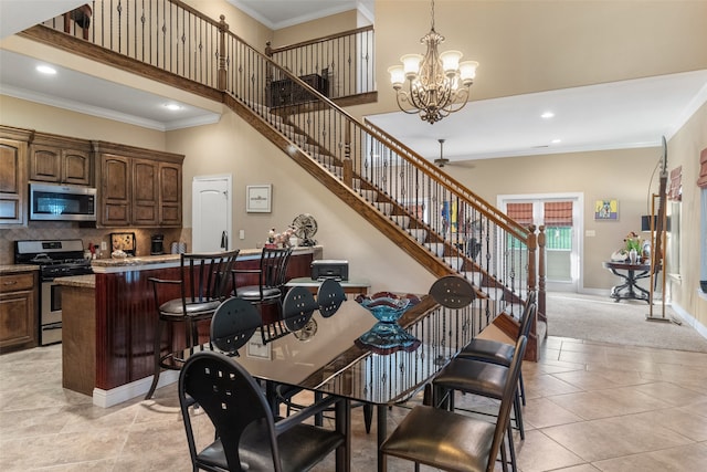 carpeted dining space with ceiling fan with notable chandelier and crown molding