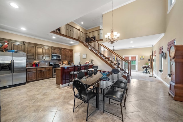 dining room with crown molding, light tile patterned floors, and a notable chandelier