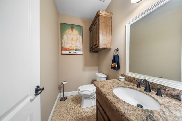 bathroom featuring tile patterned flooring, vanity, and toilet