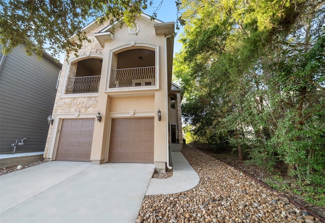 view of front of home with a garage and a balcony