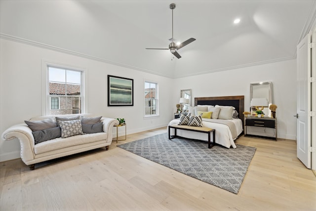 bedroom with light hardwood / wood-style flooring, ceiling fan, crown molding, and vaulted ceiling