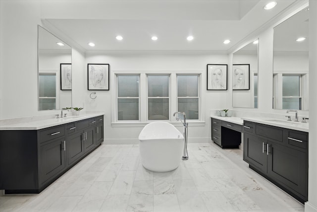 bathroom featuring a washtub and vanity