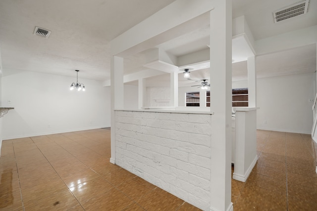 interior space with ceiling fan with notable chandelier