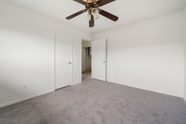 carpeted spare room with ceiling fan