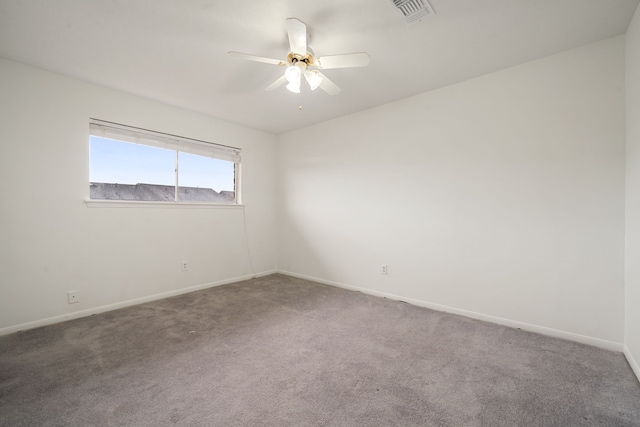 carpeted spare room featuring ceiling fan