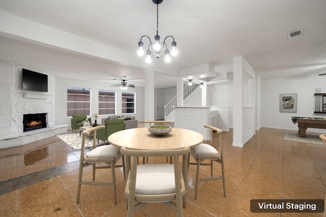 dining room featuring a fireplace, ceiling fan with notable chandelier, tile patterned floors, and billiards