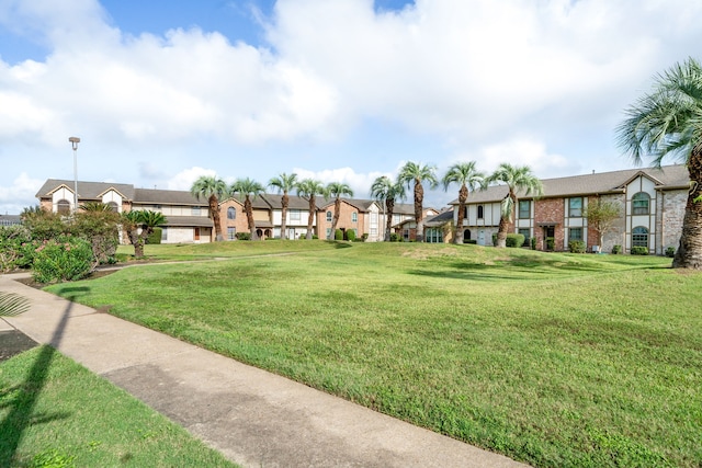 view of property's community featuring a yard