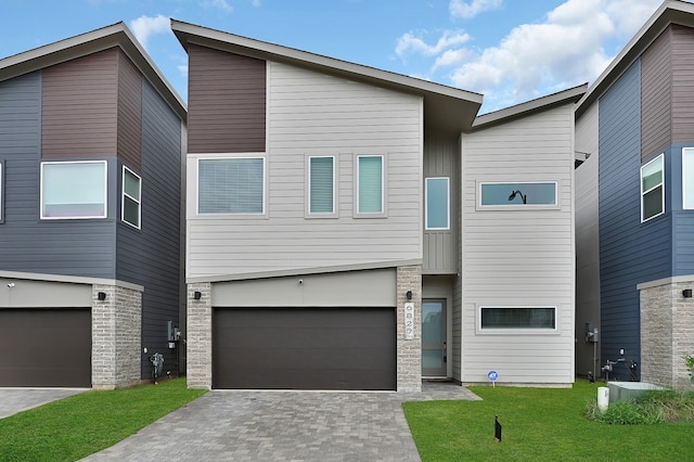 contemporary house with a front yard and a garage