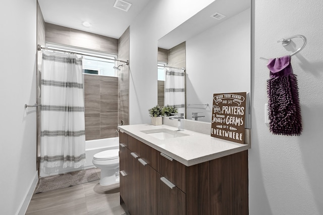 full bathroom featuring toilet, vanity, and shower / tub combo with curtain