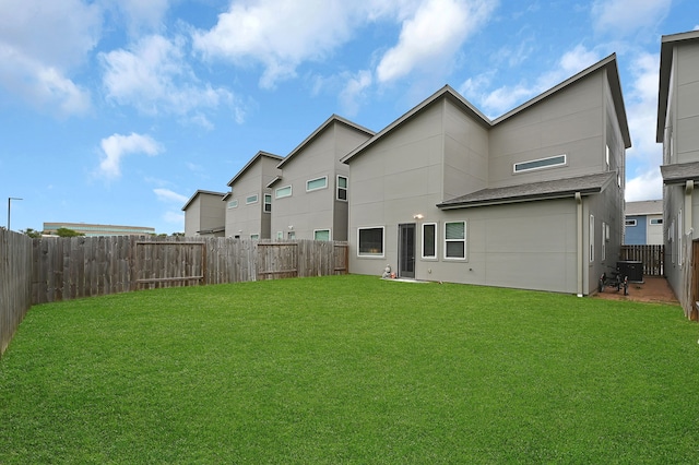 rear view of house with a yard