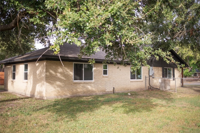 view of side of property with a lawn