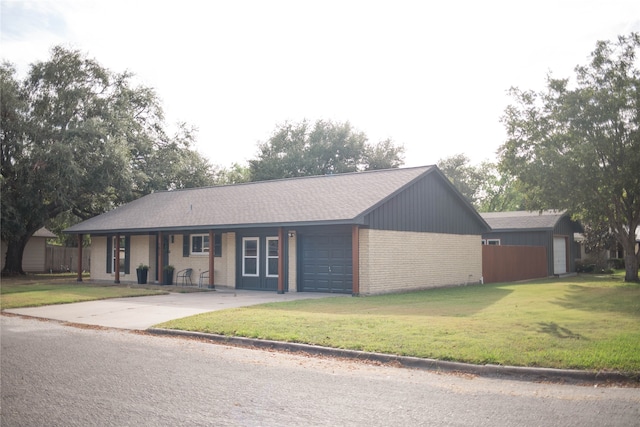 ranch-style house featuring a front lawn and a garage