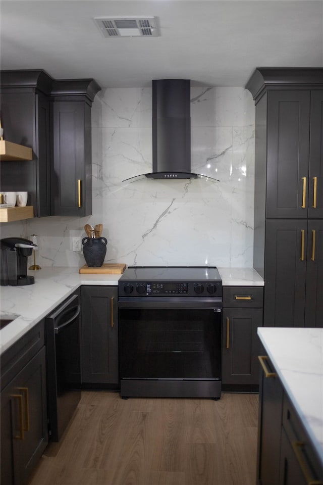 kitchen featuring black dishwasher, hardwood / wood-style floors, wall chimney exhaust hood, tasteful backsplash, and range with electric stovetop