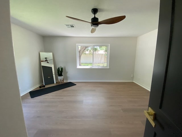 unfurnished living room with hardwood / wood-style flooring and ceiling fan