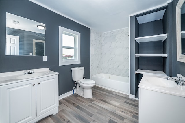 full bathroom with shower / bathing tub combination, vanity, hardwood / wood-style flooring, and toilet