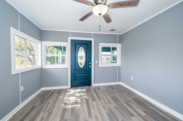 entrance foyer with hardwood / wood-style floors, ceiling fan, and crown molding