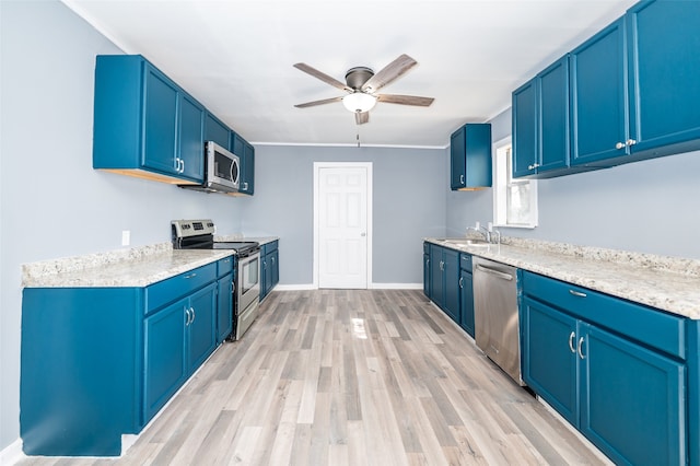 kitchen with blue cabinetry and stainless steel appliances