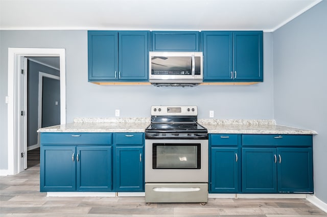 kitchen featuring blue cabinetry, light wood-type flooring, stainless steel appliances, and crown molding