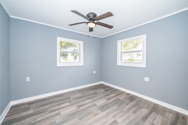 unfurnished room featuring hardwood / wood-style flooring, a healthy amount of sunlight, and crown molding