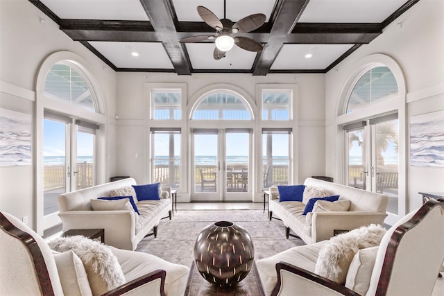 living room with beamed ceiling, coffered ceiling, french doors, and a towering ceiling