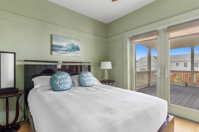 bedroom featuring hardwood / wood-style flooring and access to exterior