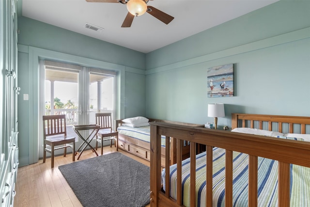 bedroom featuring light wood-type flooring, french doors, and ceiling fan