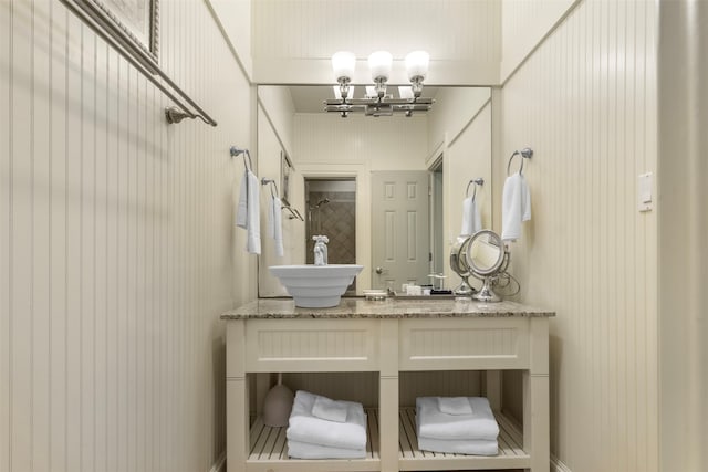 bathroom with a chandelier and vanity