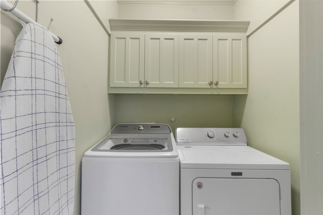 laundry room with cabinets and washing machine and clothes dryer