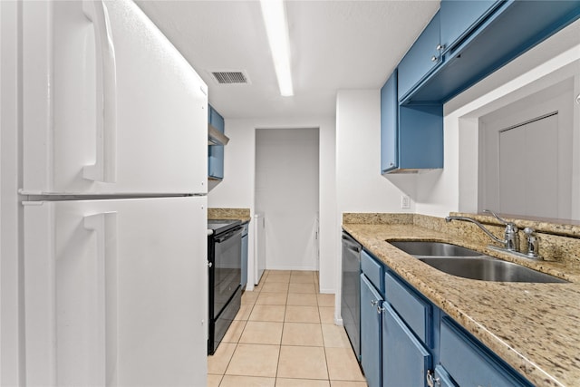 kitchen with blue cabinetry, black / electric stove, and white fridge