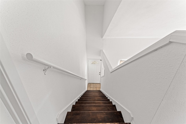 stairs featuring tile patterned floors