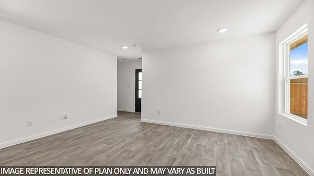 unfurnished room with light hardwood / wood-style floors