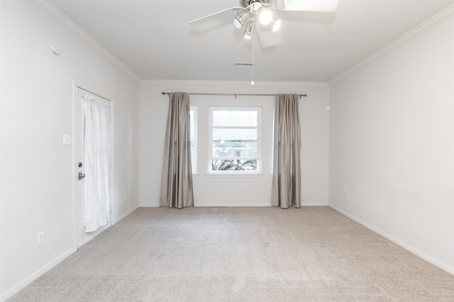 spare room featuring ornamental molding, light carpet, and ceiling fan