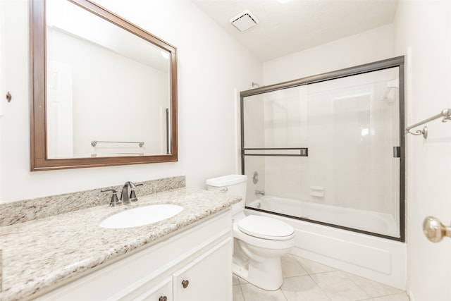 full bathroom with a textured ceiling, vanity, bath / shower combo with glass door, tile patterned floors, and toilet