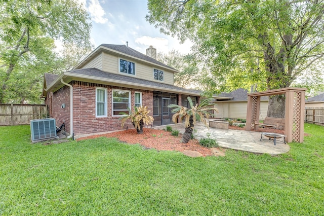 back of house featuring central AC unit, a patio, a sunroom, and a yard