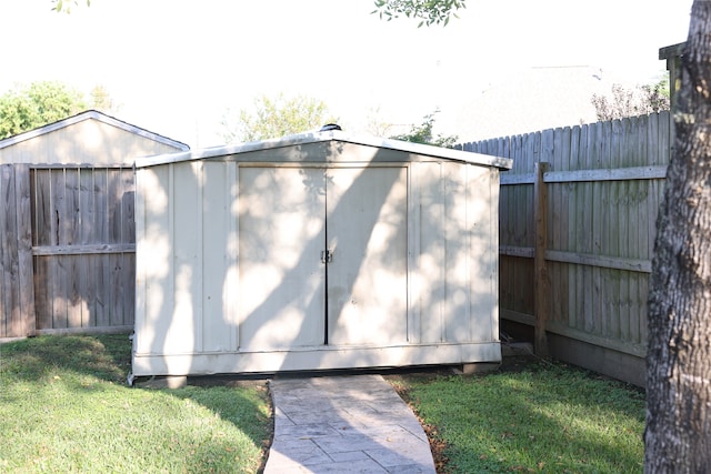 view of outbuilding featuring a lawn